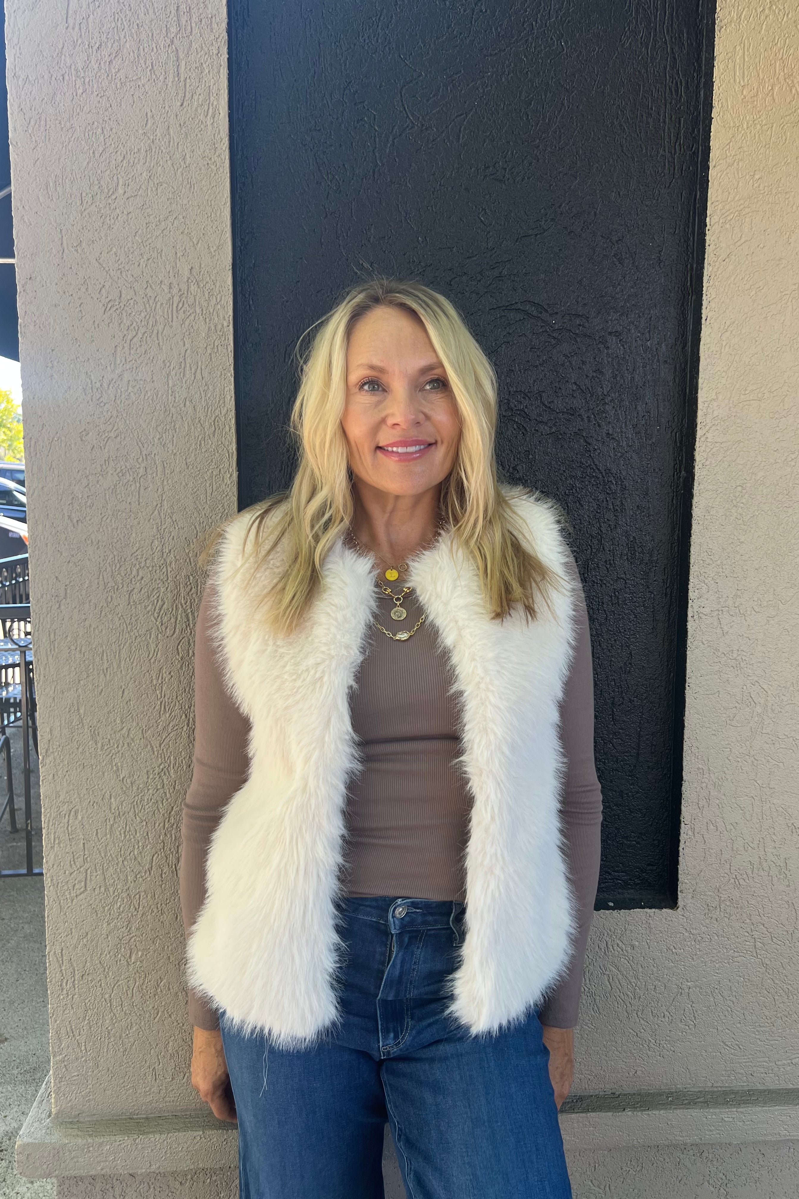 This stylish faux fur vest is the perfect layering piece for fall, versatile enough to wear casual or formal. Featuring hook closures, it falls just below the hip for an elegant silhouette. Faux fur