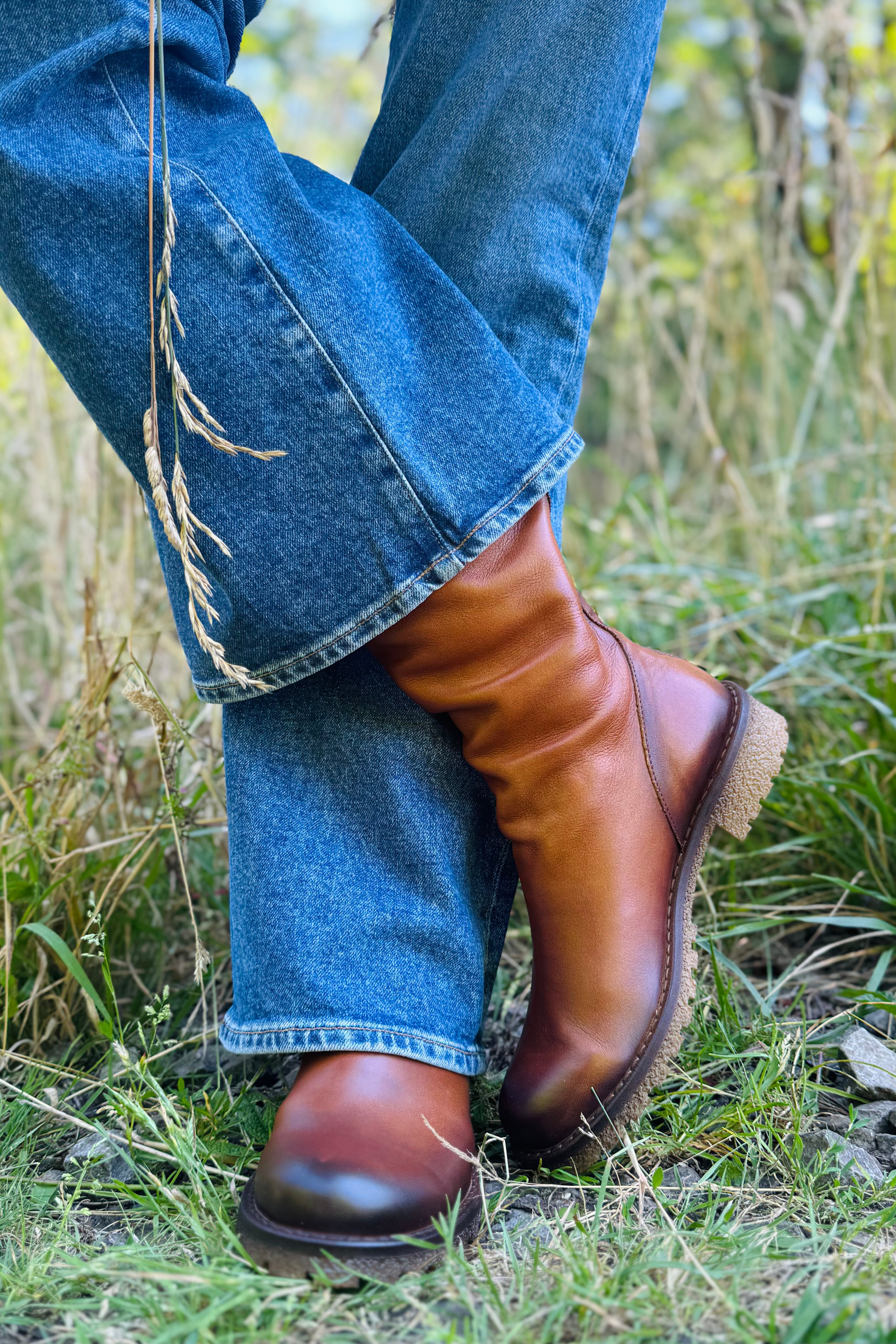 The Eric Michael Braga Boot is the perfect mix of style and comfort. Crafted from buttery-soft leather, this versatile mid-calf boot pairs effortlessly with everything from jeans and sweaters to dresses and skirts. The low block heel and back zipper make it easy to wear all day while adding the perfect finishing touch to your fall outfits.