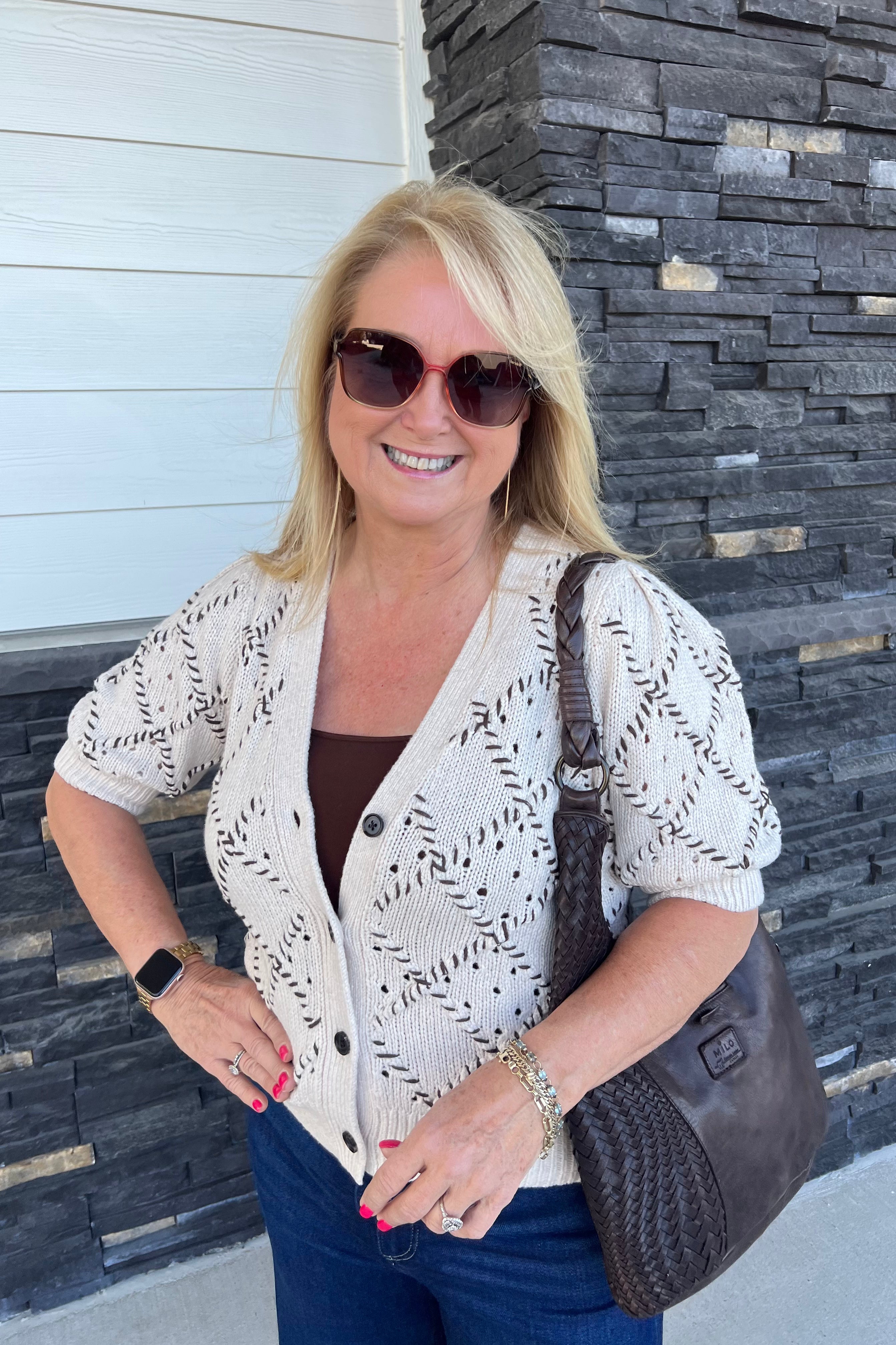Stay comfortable in a short-sleeve cardigan sweater that makes a statement. The Isla is crafted from a wool blend for cozy comfort, with an argyle texture, braided leather buttons and delicate floral adornments. Feminine and refined, the Isla effortlessly elevates any outfit.