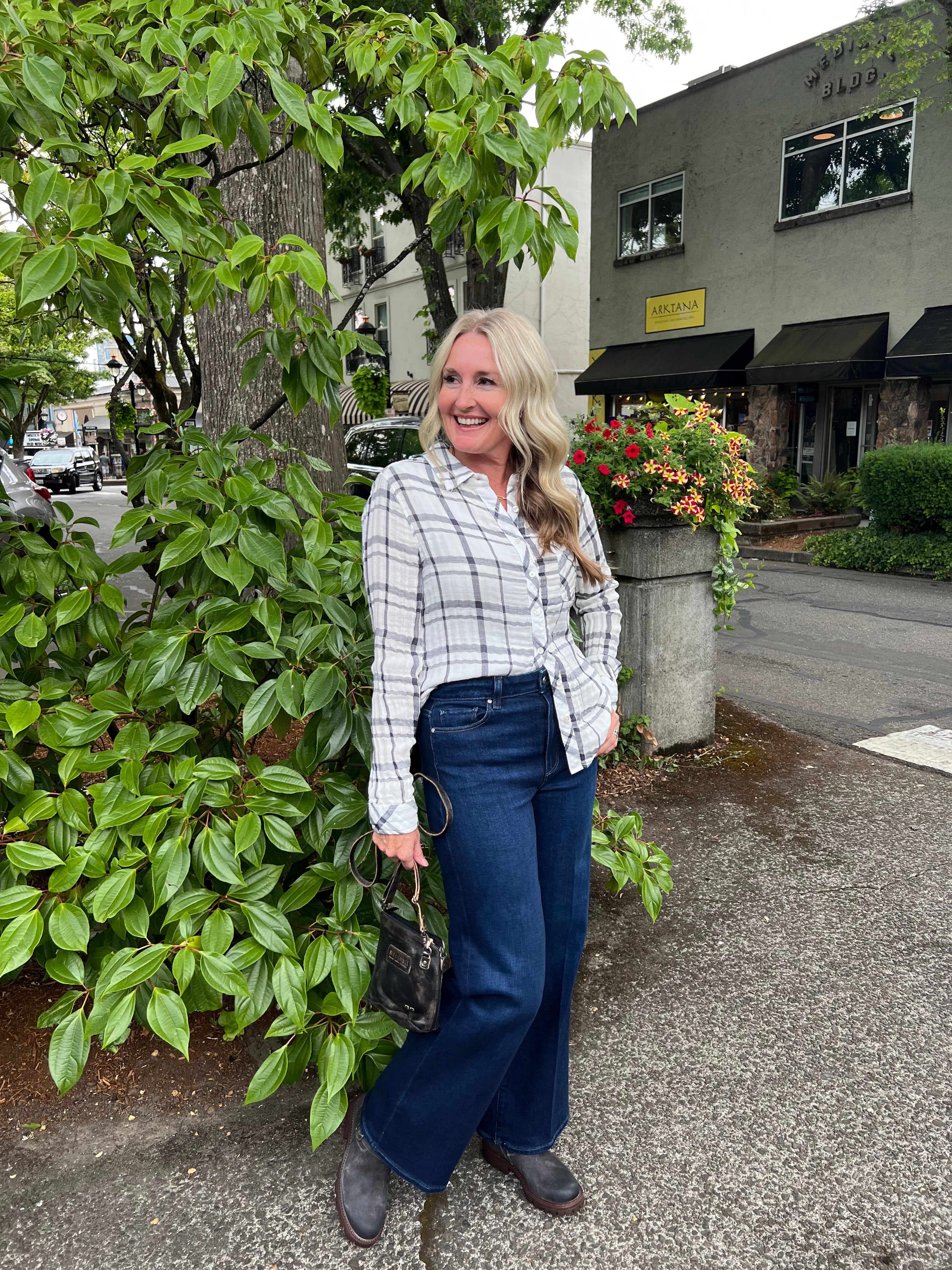 This white long-sleeve shirt is crafted from lightweight cotton gauze, offering breathability and comfort. It has a relaxed silhouette with a button-front closure and a classic collar. The gauze material provides a subtly crinkled texture, ideal for staying cool in warm conditions.