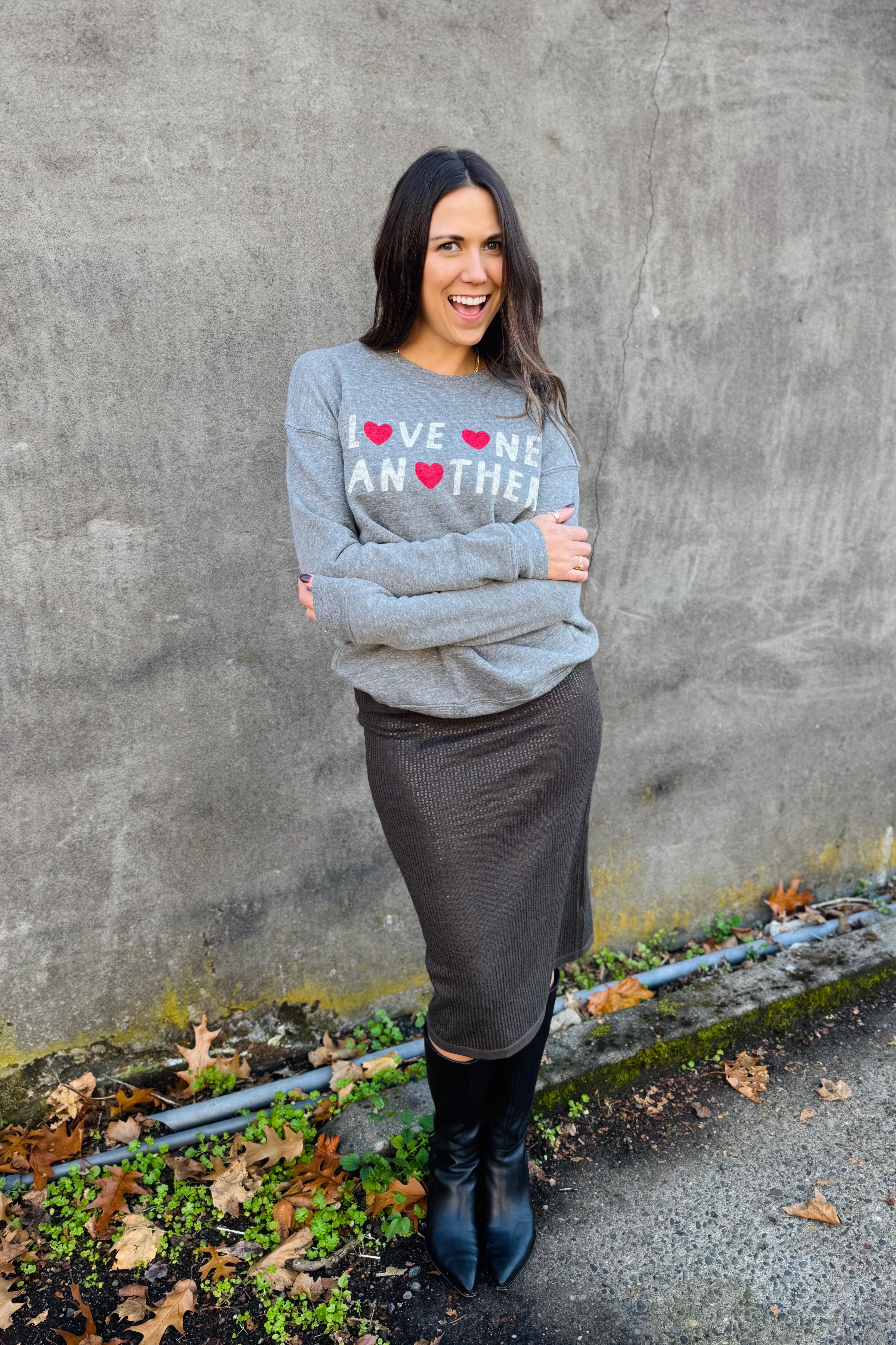 The LOVE ONE ANOTHER Graphic Sweatshirt is a unisex fleece pullover designed for comfort and style. Crafted from soft sponge fleece fabric, this relaxed-fit crewneck is perfect for everyday use and versatile layering throughout the year. It features ribbed cuffs and waistband, combining durable construction with a modern, cozy feel.