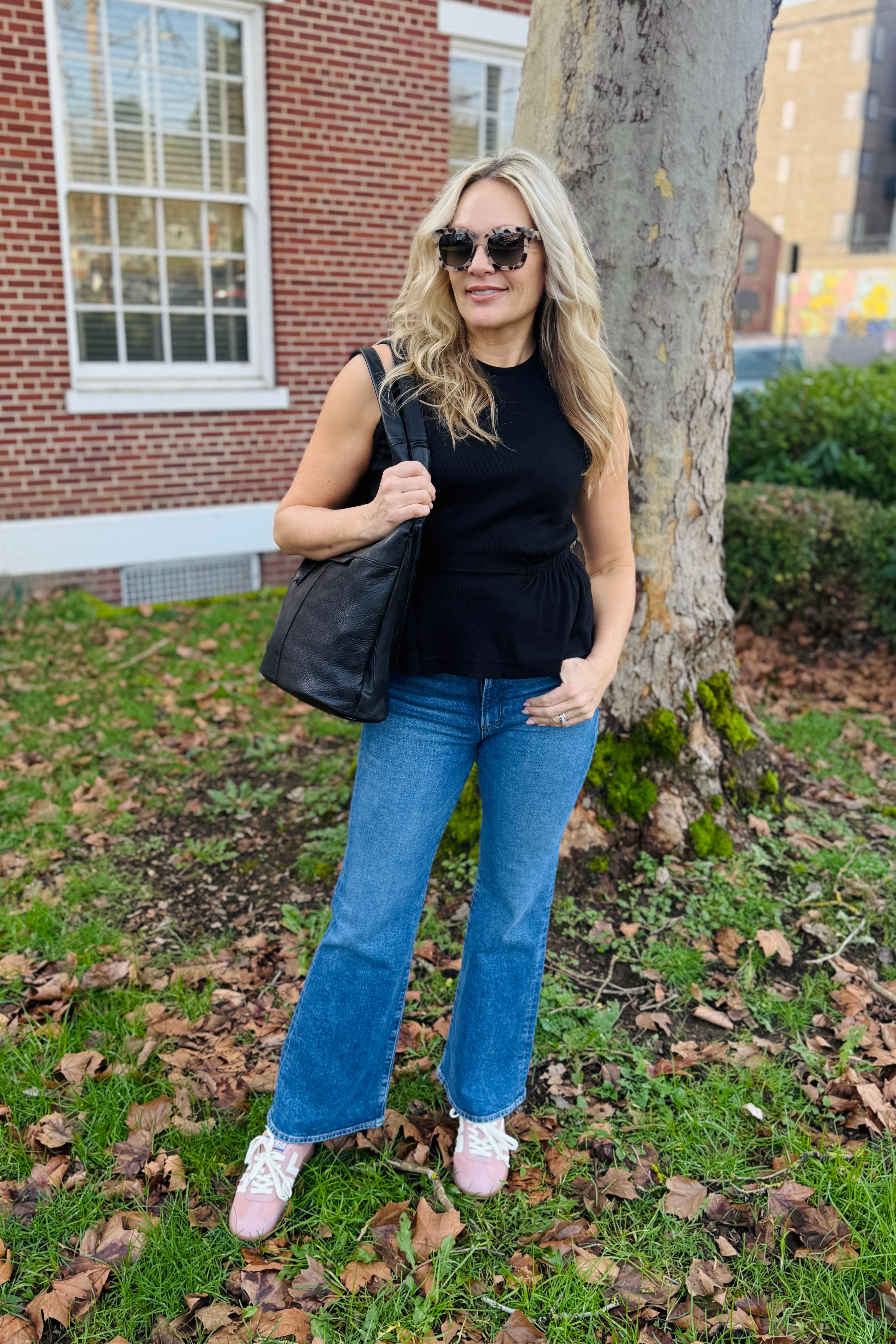 The Rochel Pepplum Tank in black combines timeless sophistication with flattering silhouette design. This sleeveless essential features a strategically ruffled waist that creates dimension and enhances your natural curves. Versatile enough for layering or wearing solo, this tank transitions seamlessly from office to evening occasions. The classic black hue pairs effortlessly with any wardrobe, making it an indispensable piece for building cohesive outfits.