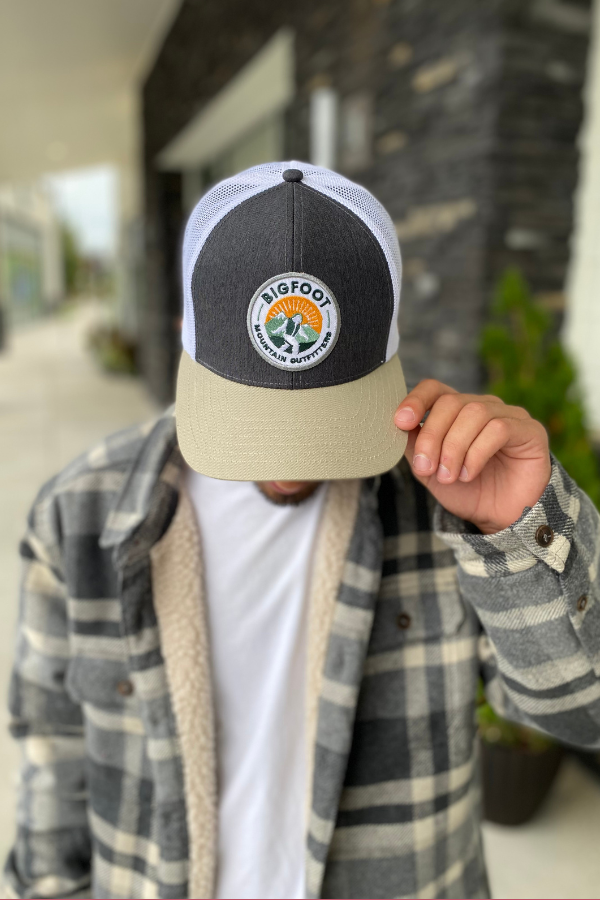 Bigfoot Mountain Outfitters original patch logo mesh back hat in Charcoal/Tan/White, a casual classic trucker hat for sunny days on the water, road trips, festivals and everyday wear