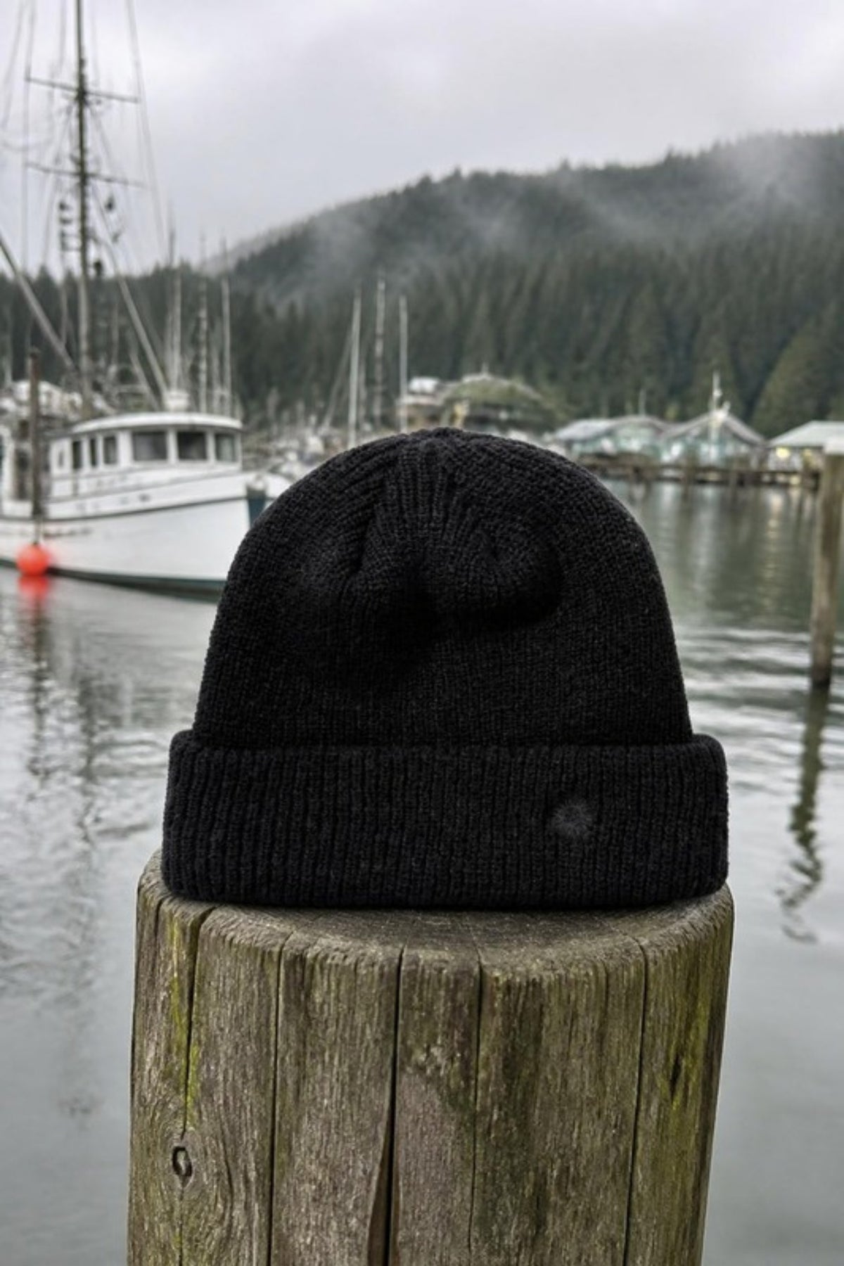 Rhythm Classic Watch Beanie in Vintage Black on a harbor dock post, a ribbed fisherman beanie for cold mornings on the water, winter walks and everyday wear