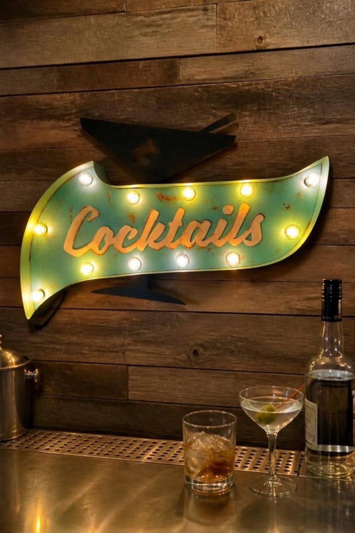 Fosterweld Cocktail marquee sign with martini glass in Teal/Black lit up over a home bar, a vintage-style lighted metal sign for the home bar, man cave, basement or patio