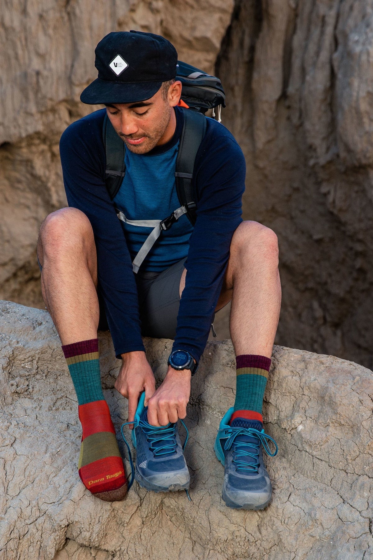 Darn Tough Heady Stripe Micro Crew Lightweight Hiking Socks in Teal worn outdoors, a lightweight cushioned merino hiking sock with retro stripes for day hikes, trail runs and everyday wear with boots or sneakers, guaranteed for life