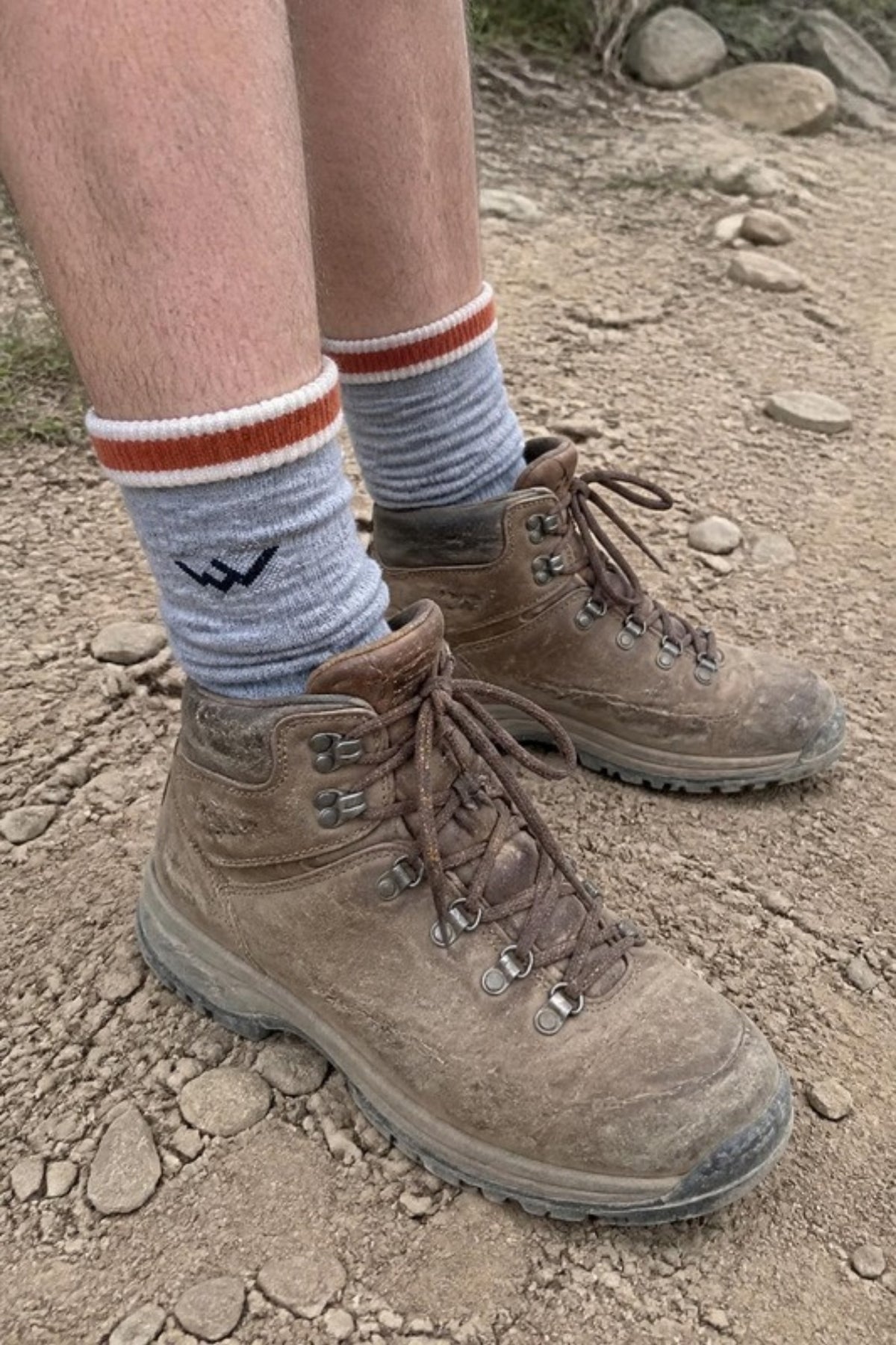 Darn Tough Men's Hiker Micro Crew Midweight 1466 Hiking Socks in Flint worn with leather hiking boots on a dusty trail, Darn Tough's best-selling cushioned merino hiking sock for long days on the trail, job sites and hunting, guaranteed for life