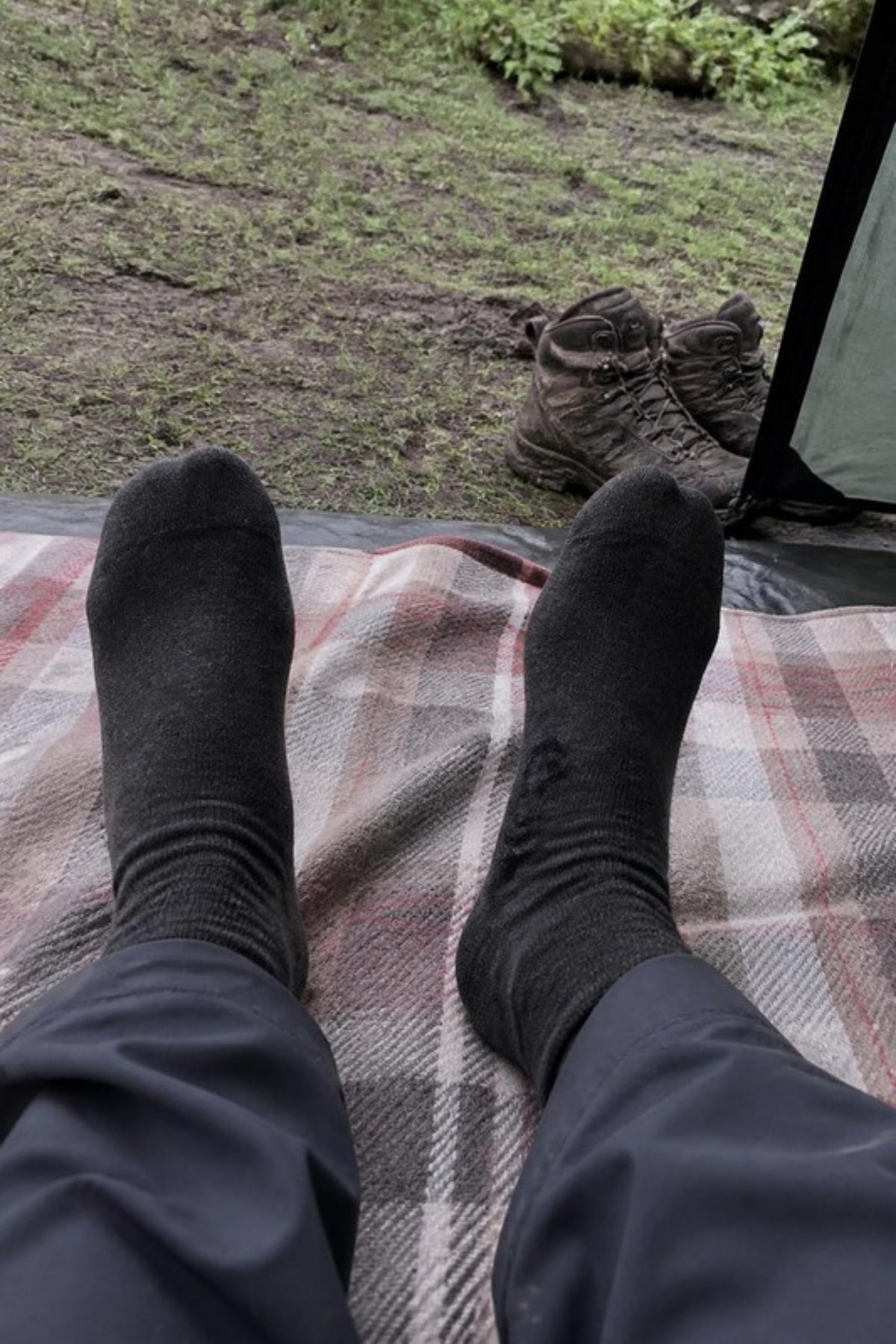 Darn Tough Men's Light Hiker Micro Crew Hiking Socks in Black worn at camp with boots off, lightweight merino hiking socks that stay dry and comfortable on day hikes, backpacking trips and lounging around camp, guaranteed for life
