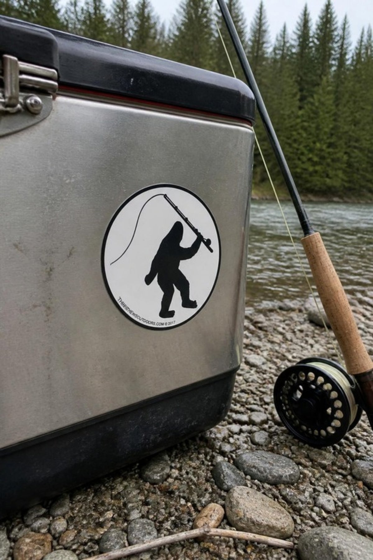 Bigfoot Mountain Outfitters Round Bigfoot Fly Fishing Sticker on a cooler by the river, a vinyl Bigfoot fly fishing decal for coolers, drift boats, truck windows and tackle boxes
