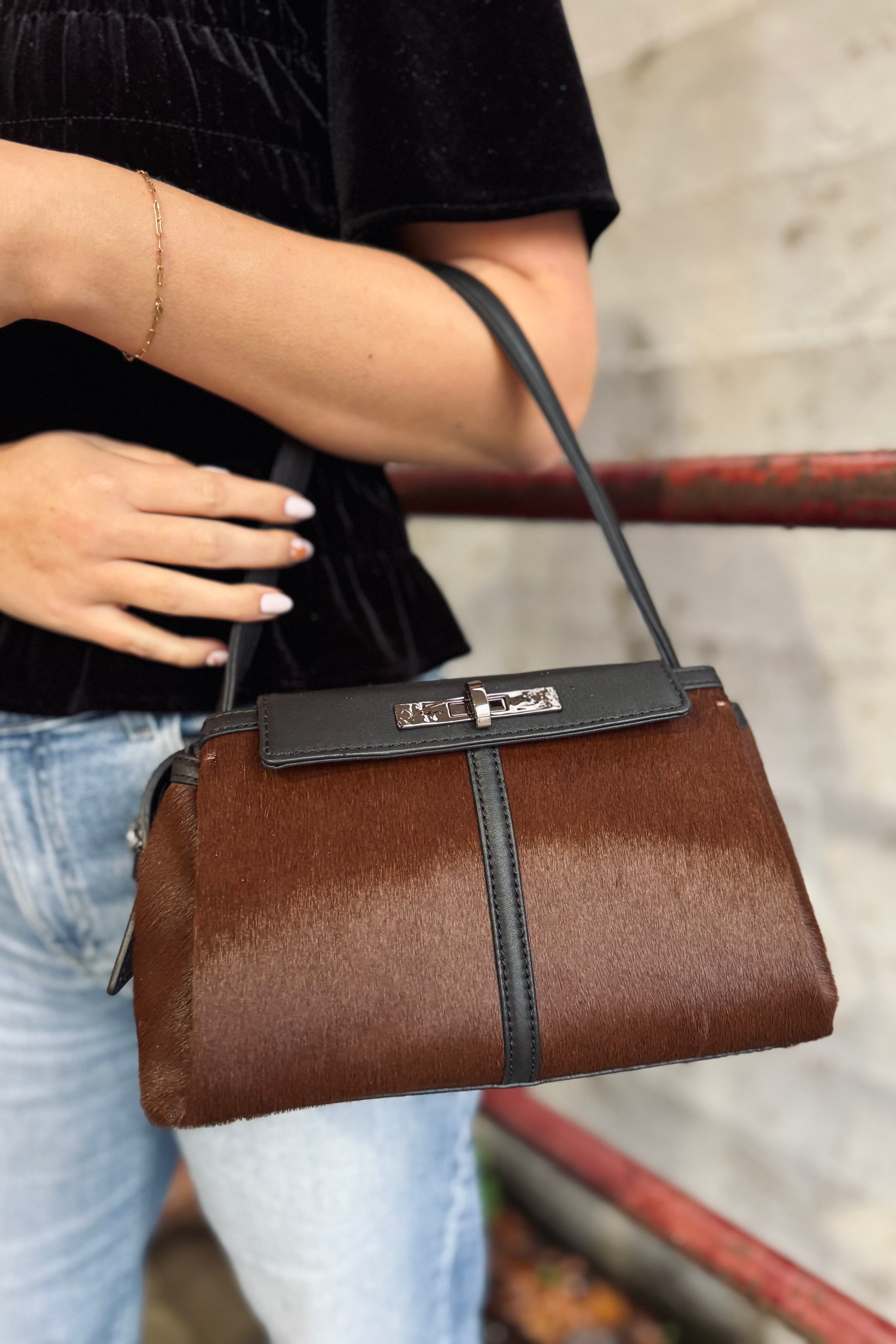 The Charlotte Med is an elevated new silhouette, with a beautiful long drop shoulder strap, and a crossbody strap option, featuring a beautiful water-inspired lock on the front pocket. This bag has a large capacity with two main compartments, both with large magnetic gussets that open wide easily for easy access.