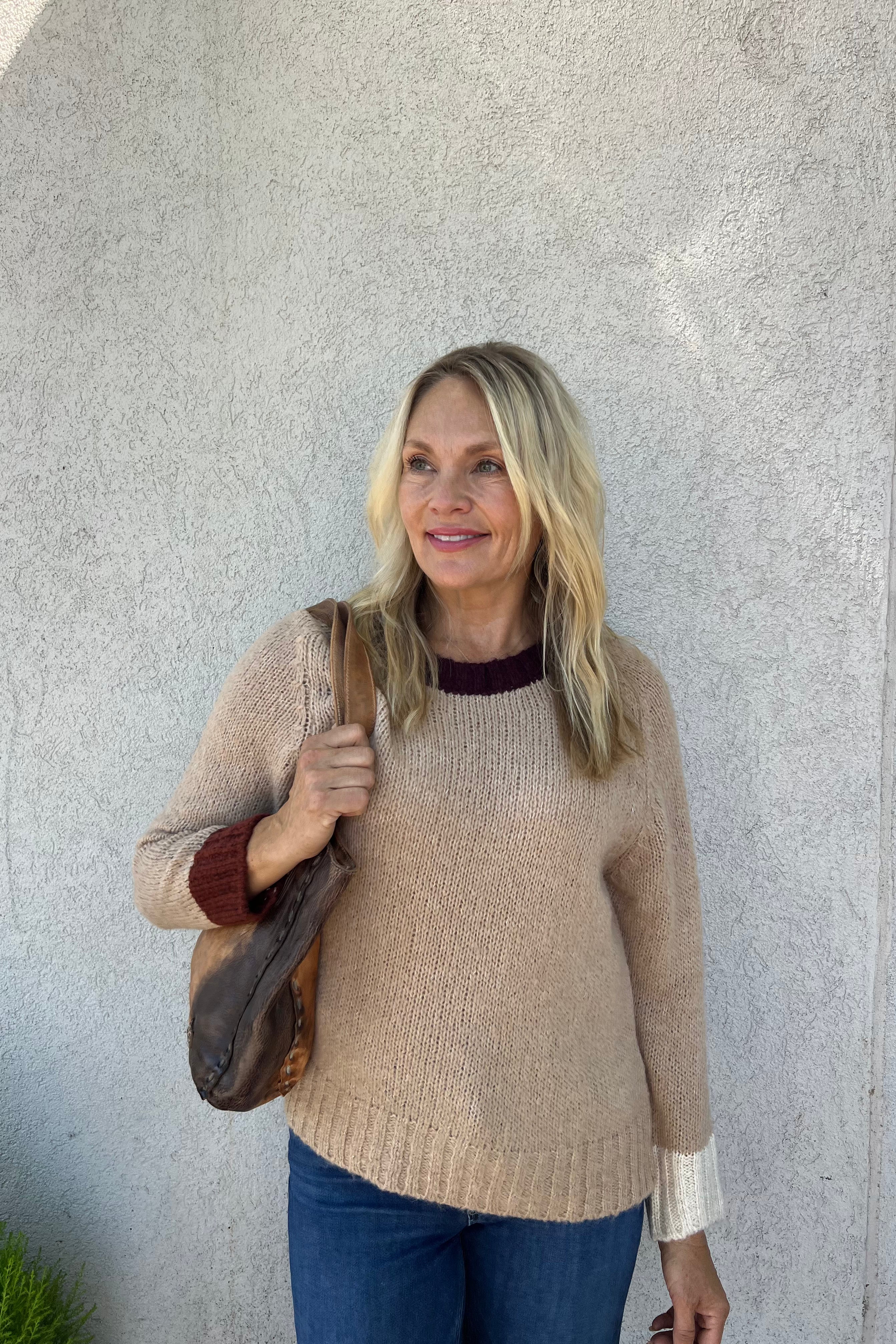 The Farris Sweater features a luxurious soft texture and rich color contrast at the neckline and cuffs. It includes a scooped neckline, extended sleeves, and a subtly ribbed hem, designed with a relaxed, slightly oversized fit for comfortable wear.