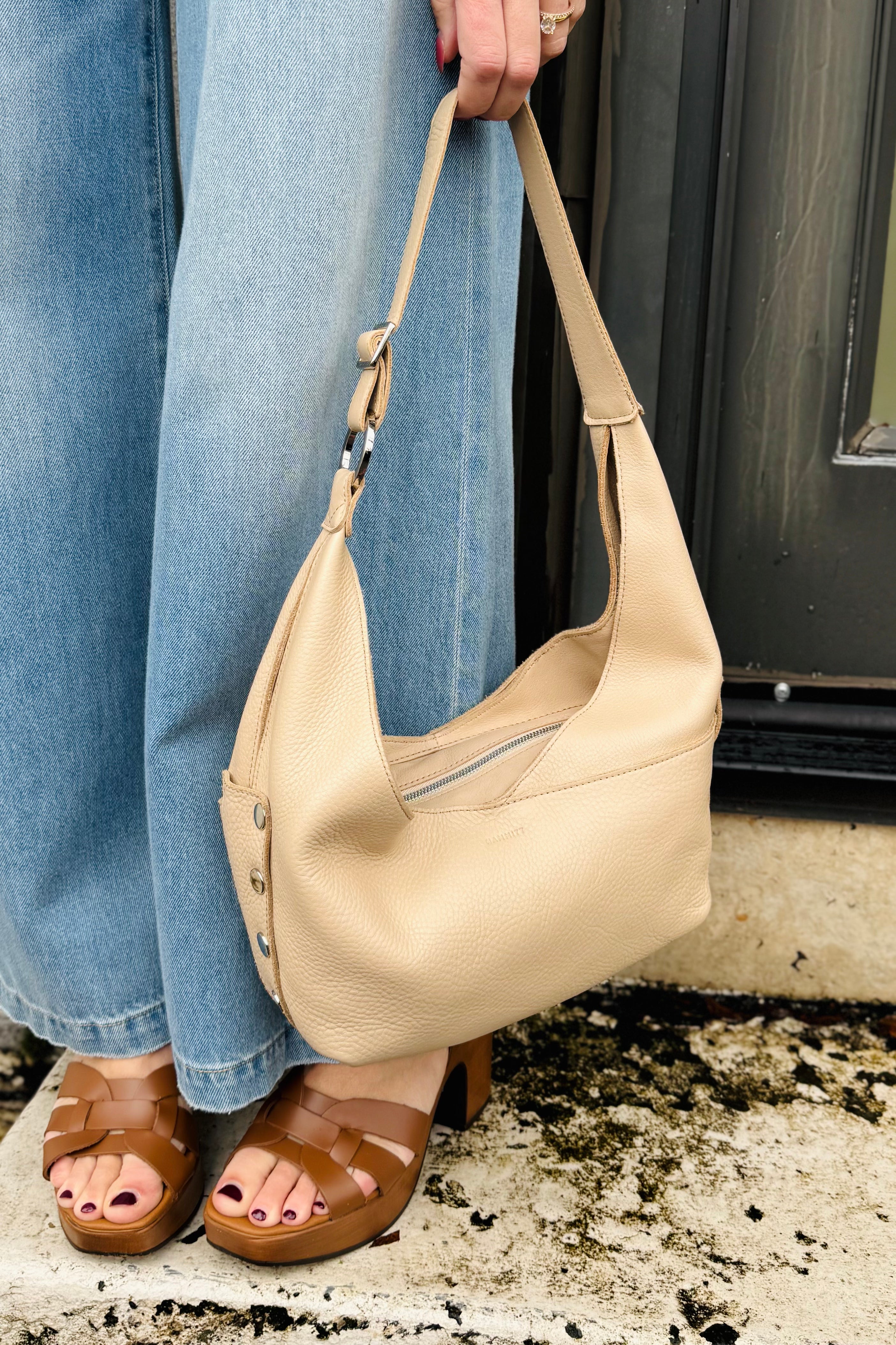 This Hammitt handbag is the cutest but also pracititcal bag! lots of features and great versital bag to take with you anywhere. Leather is a beauitful beige color with silver grommets