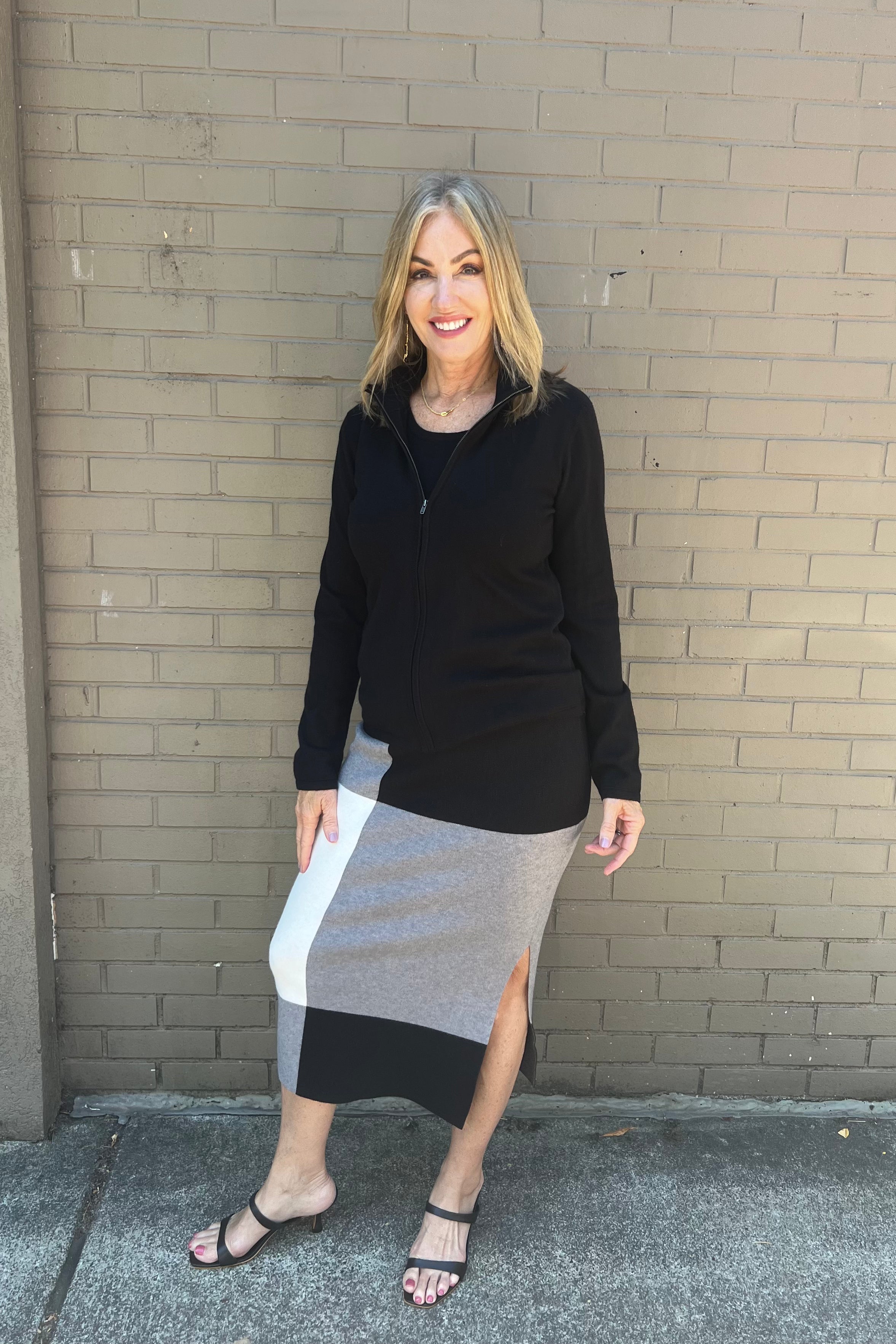 This mock neck zip sweater features a full zipper and combines 95% cotton with 5% cashmere, offering an ideal weight for transitioning into fall. Mock neck and Full zip