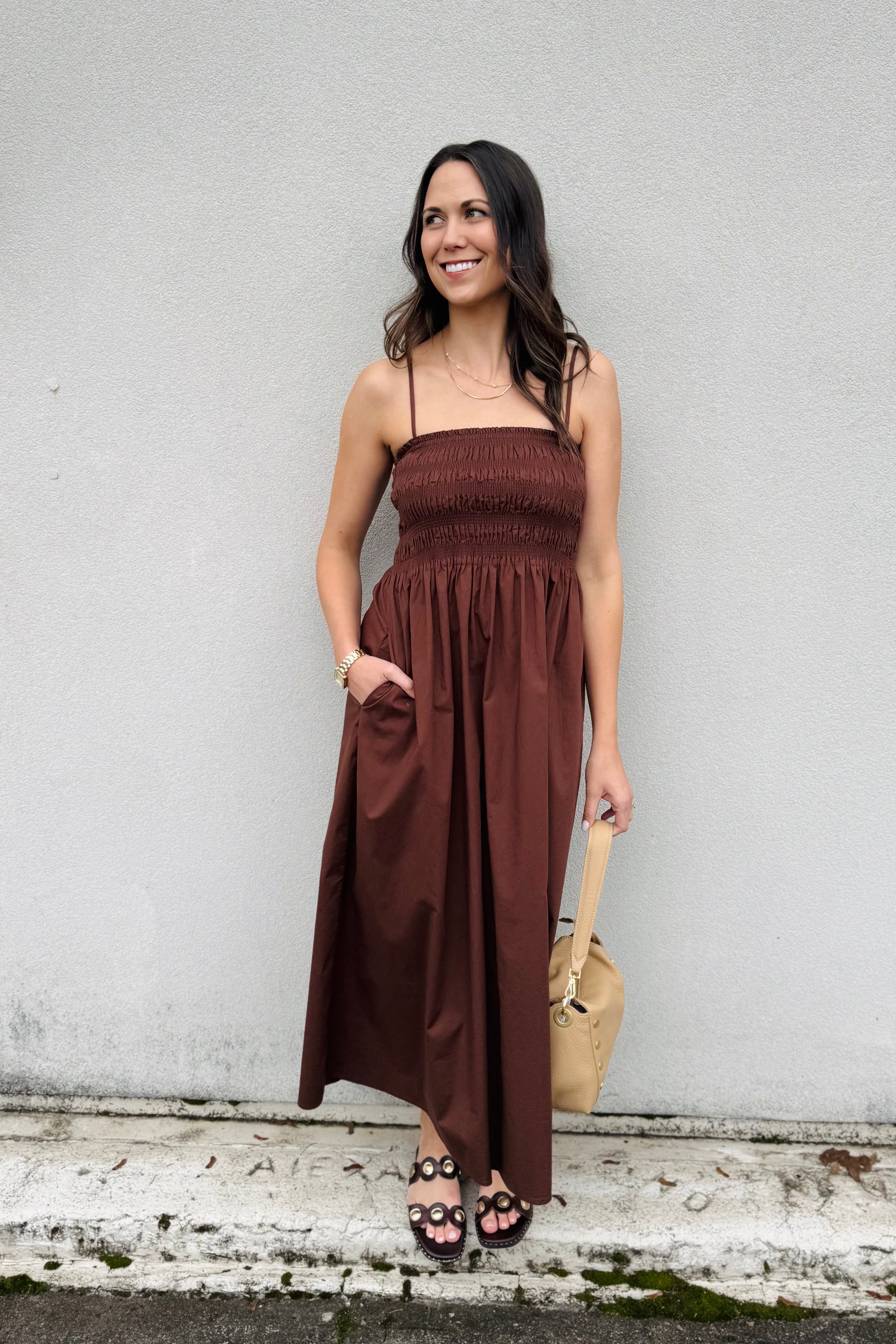 This maxi is one of those easy, throw-it-on-and-feel-pretty dresses. The lightweight sateen drapes so beautifully but still holds its shape, and the smocked bodice gives it that flattering, comfy fit at the waist. The square neckline and adjustable straps make it easy to customize, and yes — it has pockets (we love that). Just slip it on and you’re ready for dinner, a summer event, or even a dressed-up day around town. Effortless but still elevated.