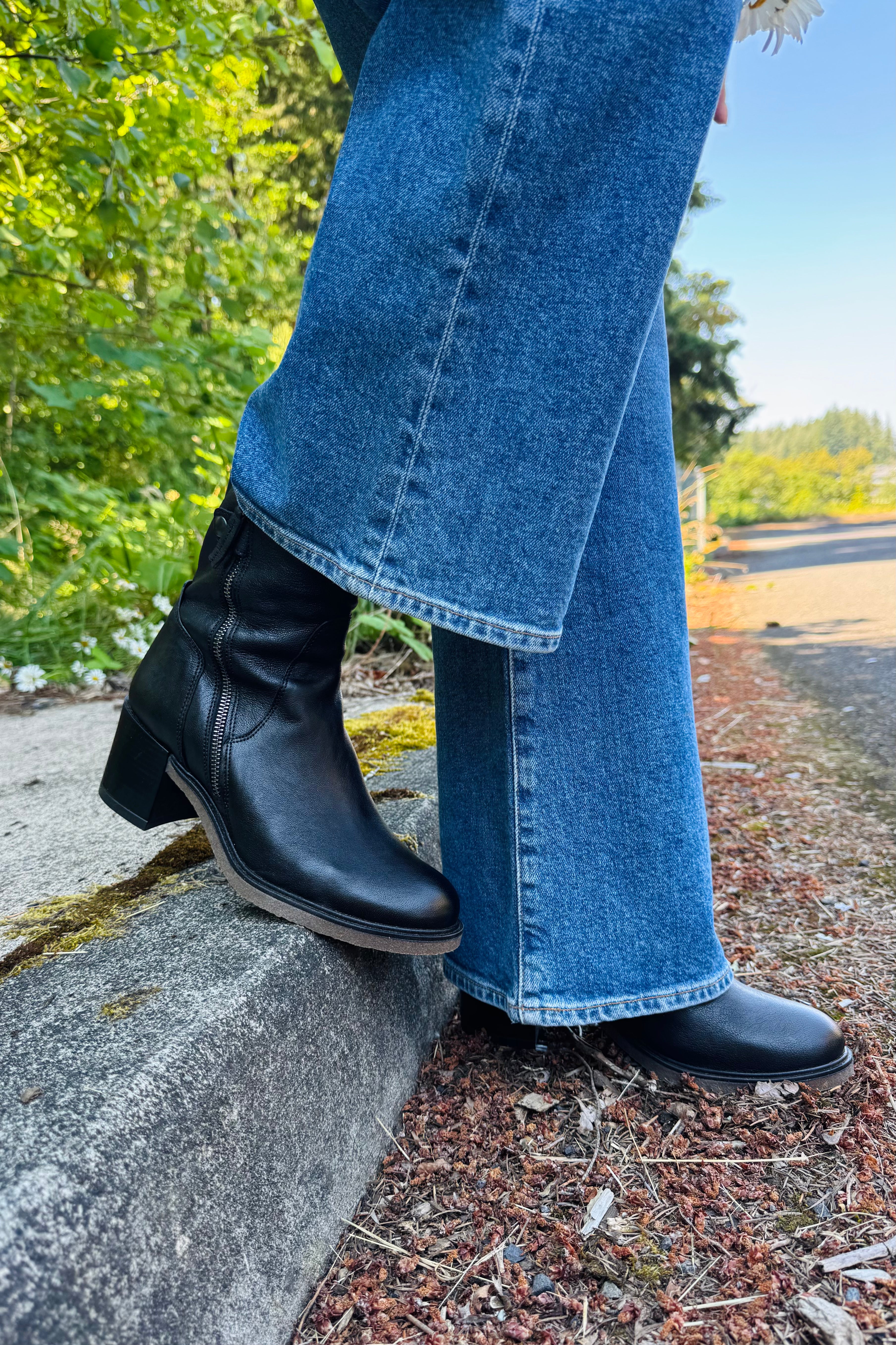 A timeless black leather boot you'll wear for years to come. The sleek design pairs effortlessly with jeans, dresses, and skirts, while the comfortable block heel makes it easy to wear from day to night. Finished with a modern side zip detail, it's the perfect go-with-everything boot for fall.