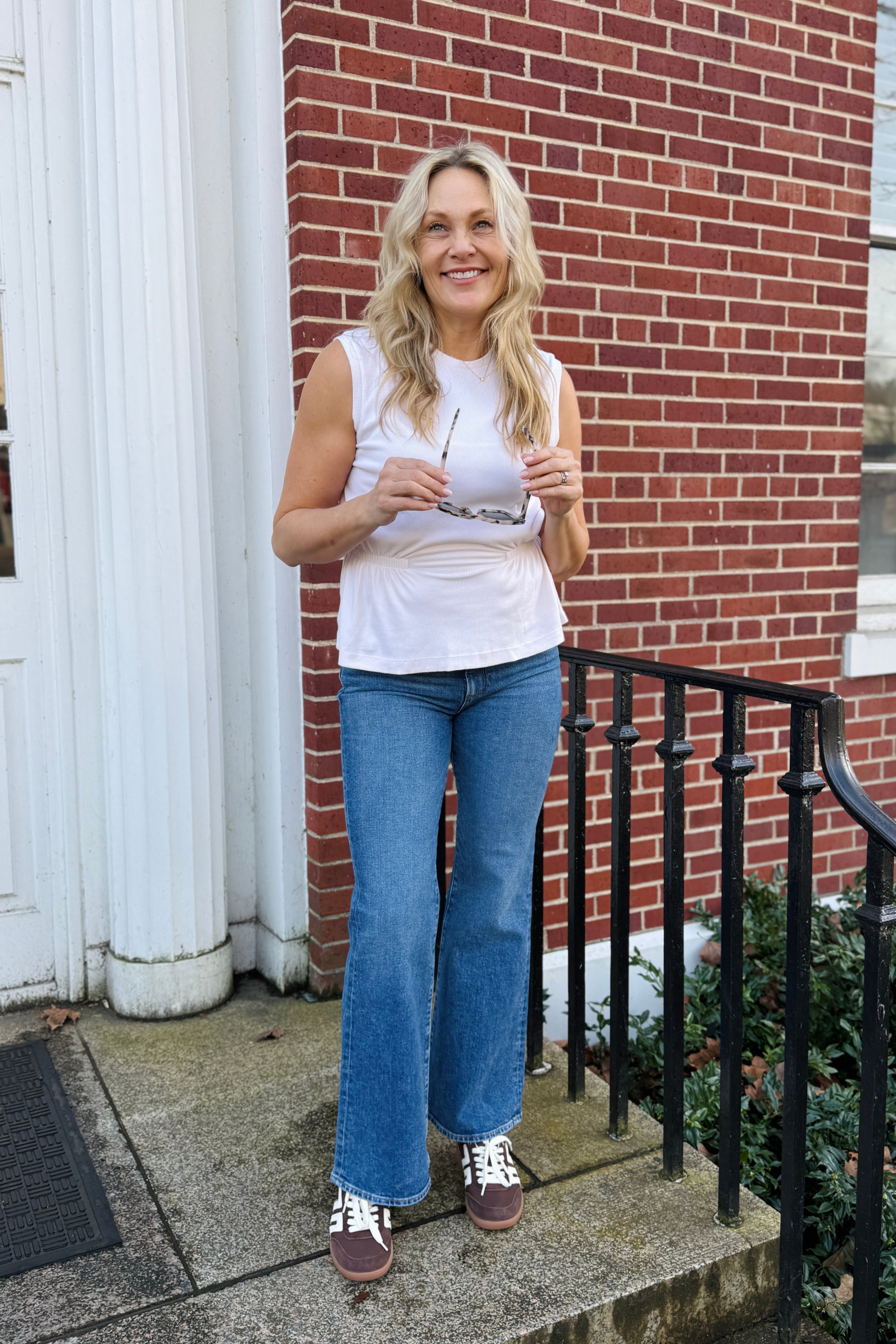 The Rochel Pepplum Tank in chalk combines timeless sophistication with flattering silhouette design. This sleeveless essential features a strategically ruffled waist that creates dimension and enhances your natural curves. Versatile enough for layering or wearing solo, this tank transitions seamlessly from office to evening occasions. The classic black hue pairs effortlessly with any wardrobe, making it an indispensable piece for building cohesive outfits.