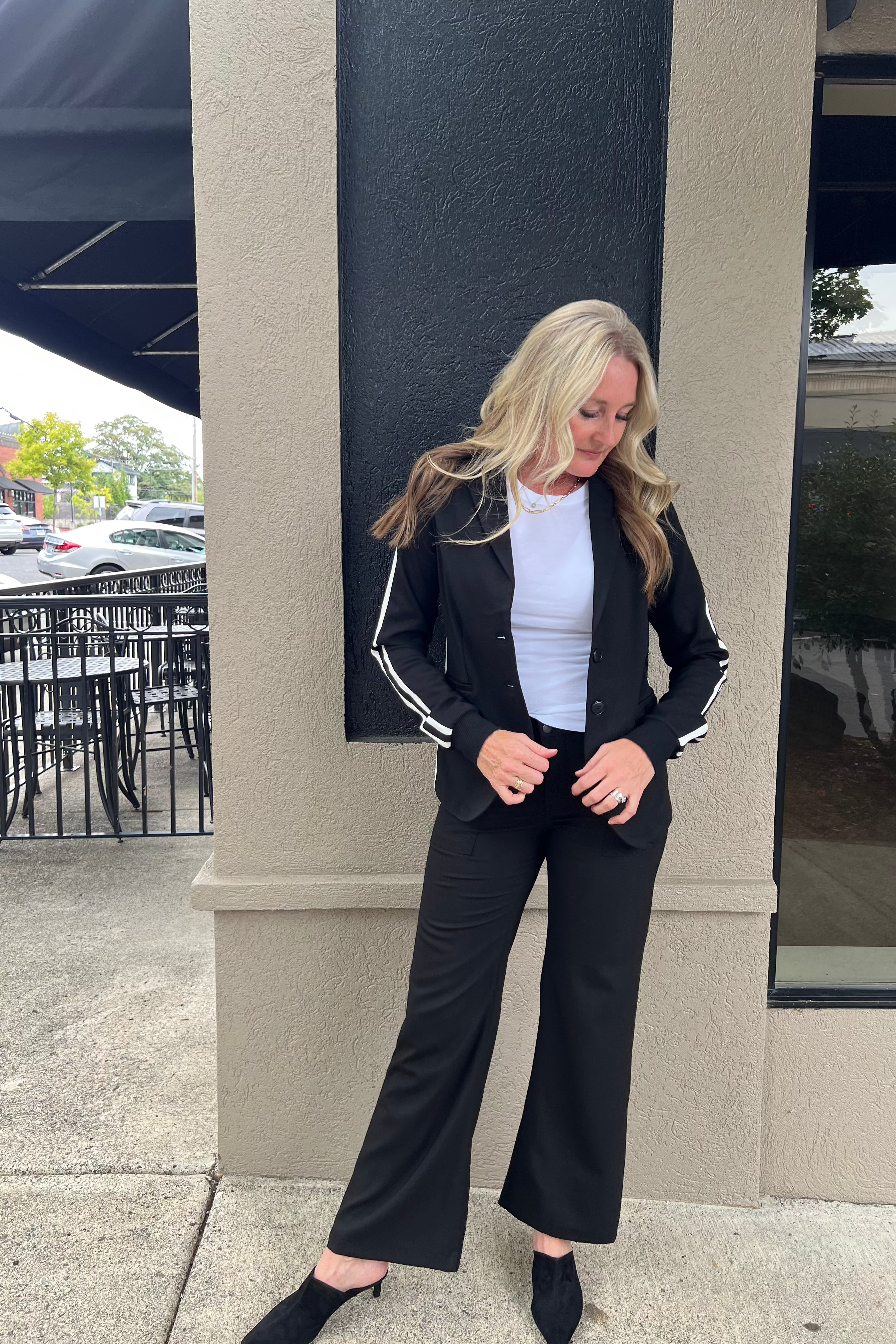 This versatile blazer is sure to impress wherever you wear it. Pair it with jeans or slacks for a polished look, or dress it down with sweatpants, a casual tee, and sneakers. Crafted from a comfortable two-button knit fabric, it combines style and ease effortlessly.