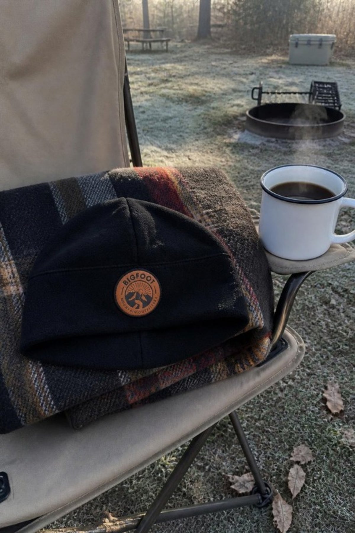 Bigfoot Mountain Outfitters BMO Fleece Beanie in Black on a camp chair on a frosty morning, a warm fleece beanie with a leather patch for cold camp mornings, winter hikes and everyday wear