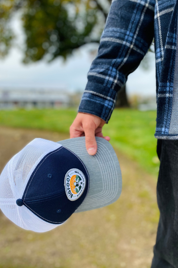 Bigfoot Mountain Outfitters original patch logo mesh back hat in Navy/Charcoal/White, a casual classic trucker hat for sunny days on the water, road trips, festivals and everyday wear