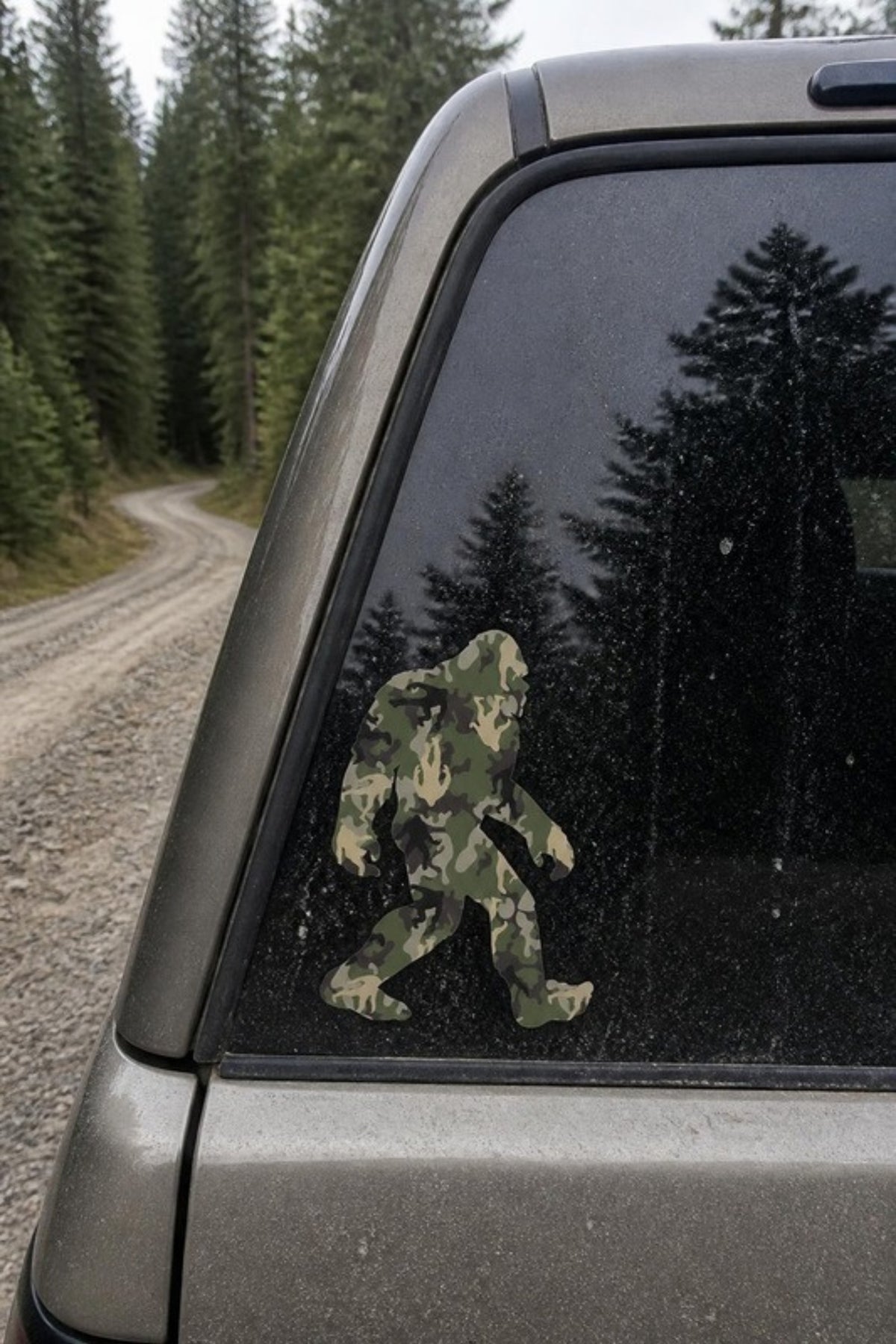 Paradise Cay Publications Camo Sasquatch sticker in green woodland camo on a truck back window, a laminated vinyl Bigfoot decal for trucks, coolers, water bottles and toolboxes