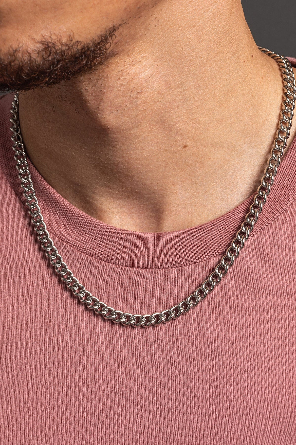 We Are All Smith 7mm Curb Style Link Chain worn with a tee, a thick waterproof stainless steel curb chain for a bold everyday look