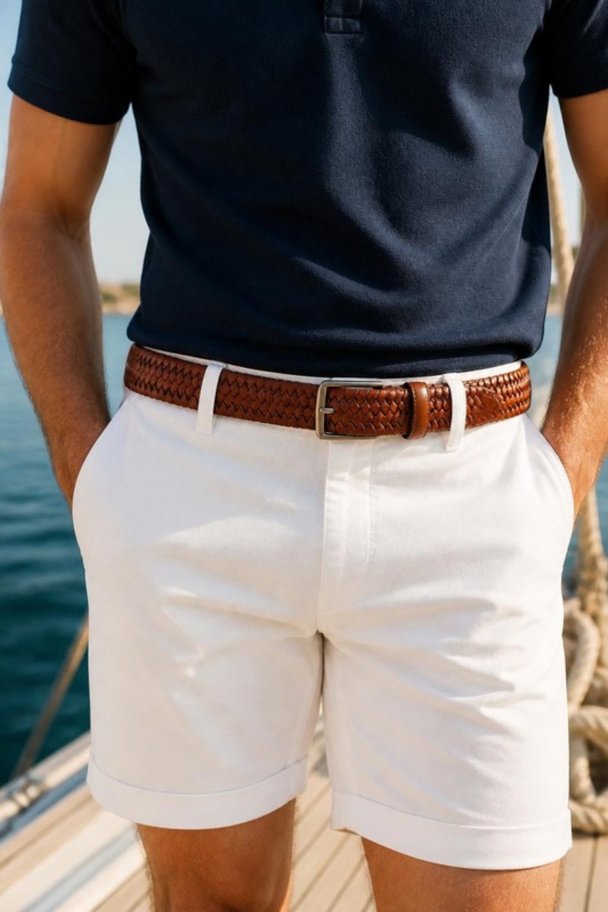 Johnston & Murphy Leather Braided Belt in Cognac worn with white shorts and a navy polo on a sailboat dock, a relaxed braided leather belt for summer weekends, boating, golf and vacation