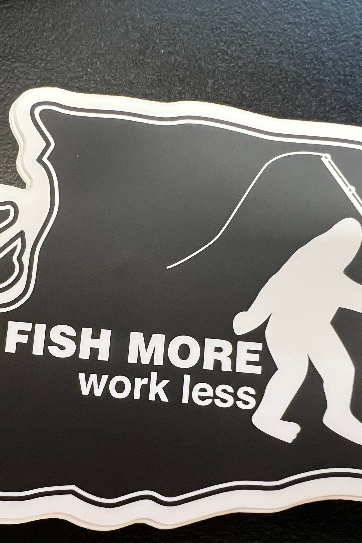 Bigfoot Mountain Outfitters Washington Fish More Work Less Sticker on a truck window at the boat launch, a Washington state Bigfoot fishing decal for trucks, coolers and drift boats